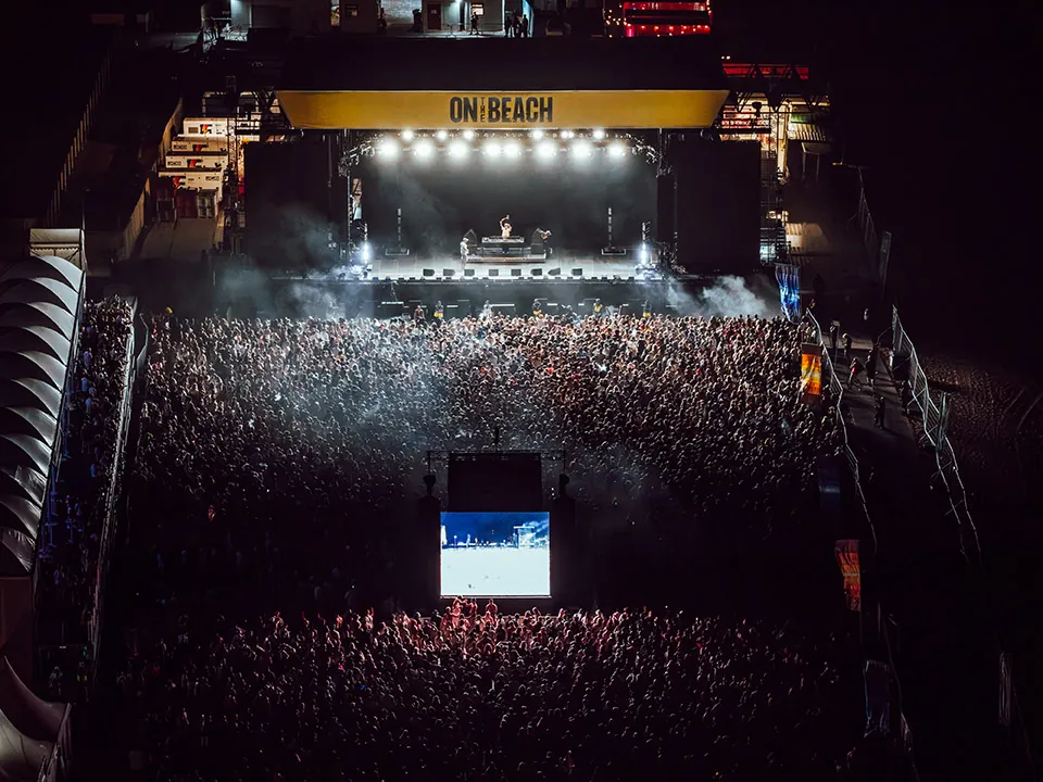 Laser lights illuminating the beach festival stage